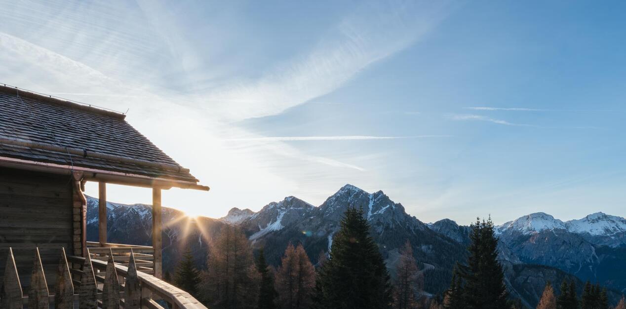 Wooden chalet with views of the Dolomites and the sunrise.